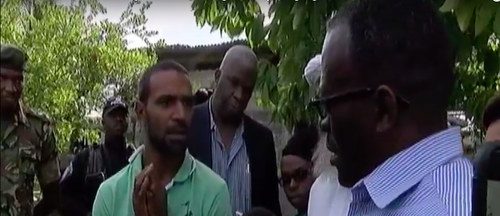 Photo: National Security Minister Edmund Dillon (right) trolls gang member Abdul "Krysis" Wakeel on his home turf in Crown Trace while Deputy Commissioner (Crime) Wayne Dick (background) looks on.