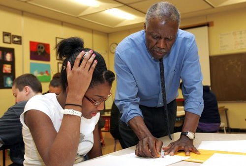 Photo: A teacher (right) offers some help to his student. (Courtesy Mase TV)