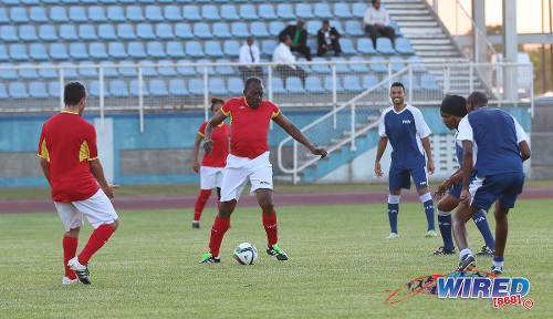 Photo: National Security Minister Edmund Dillon (centre) makes a move during an exhibition match against a FIFA/TTFA All Star team at the Ato Boldon Stadium in Couva on 10 April 2017. (Courtesy Sean Morrison/Wired868)