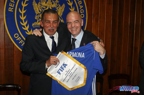 Photo: FIFA president Gianni Infantino (right) bears gifts for Trinidad and Tobago President Anthony Carmona in a courtesy call at President's House in St Ann's on 10 April 2017. (Courtesy Sean Morrison/Wired868)