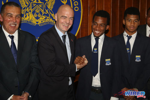 Photo: FIFA president Gianni Infantino (second from left) greets Fatima College captain Keyon Williams (second from right) while his teammate Stephon Marcano (far right) and Trinidad and Tobago President Anthony Carmona look on at President's House in St Ann's on 10 April 2017. (Courtesy Sean Morrison/Wired868)