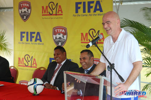 Photo: FIFA president Gianni Infantino (right) charms SPORTT chairman Michael Phillips (centre) and Sport Minister Darryl Smith at a press conference at the Ato Boldon Stadium in Couva on 10 April 2017. (Courtesy Sean Morrison/Wired868)