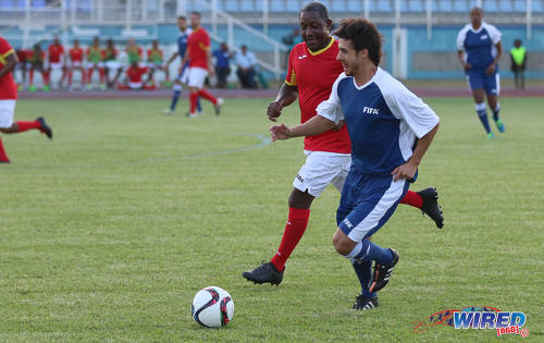 Photo: Former Argentina World Cup star Pablo Aimar (right) runs at Trinidad and Tobago 2006 World Cup midfielder Russell Latapy during an exhibition match at the Ato Boldon Stadium in Couva on 10 April 2017. (Courtesy Sean Morrison/Wired868)