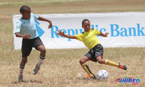 Photo: Trincity Hawks ‘2’ forward Jaydon McShine (right) takes on a QPCC ‘1’ defender during RBNYL North Zone Under-11 action at the Queen's Park Savannah on 22 April 2017. McShine scored but the Hawks lost 5-1. (Courtesy Sean Morrison/Wired868)