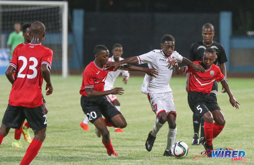 Photo: Republic Bank XI attacker Keron Manswell (centre) holds off Trinidad and Tobago National Under-15 players Tristan Caesar (left) and Jarique Williams during action at the Ato Boldon Stadium on 15 April 2017. (Courtesy Sean Morrison/Wired868)