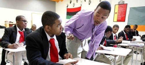 Photo: A teacher (right) interacts with his student at class. (Copyright Raa Network)