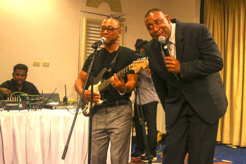 Photo: Trinidad and Tobago Football Association (TTFA) president David John-Williams (right) performs a duet with former Calypso Monarch, Cro Cro, at the launch of the National Elite Youth Development Program at the Trinidad Hilton on 14 October 2016.