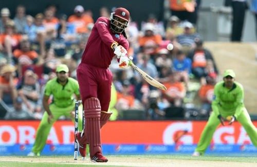 Photo: West Indies batsman Chris Gayle (centre) hits out against the Pakistan bowling during their 2015 Cricket World Cup Group B match in Christchurch on 21 February 2015. (Copyright AFP 2017/William West)