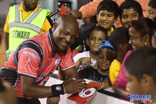 Photo: West Indies cricket icon Brian Lara (left) signs autographs during the opening of the Brian Lara Cricket Stadium in Tarouba on 12 May 2017. (Courtesy Sean Morrison/Wired868)