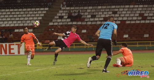 Photo: Central FC midfielder Sean De Silva (centre) goes for the acrobatic during 2017 Caribbean Club Championship action against Cibao FC at the Hasely Crawford Stadium on 18 May 2017. Soko scored the winner as Cibao edged Central for a place in the regional final. (Courtesy Sean Morrison/Wired868)