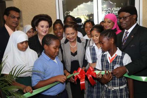 Photo: Then Prime Minister Kamla Persad-Bissessar (centre) assists St Joseph TML and St Joseph Government Primary School students in cutting the ribbon to open officially the Children’s Authority Assessment Centre at the Eric Williams Medical Sciences Complex in Mt Hope. Also in photo (from left) are Health Minister Dr Fuad Khan, Children’s Authority board chairperson Stephanie Daly SC, Children’s Authority director Sharifa Ali-Abdullah and then Minister of Gender, Youth and Child Development Clifton De Coteau. (Copyright Andre Alexander/Trinidad Guardian)