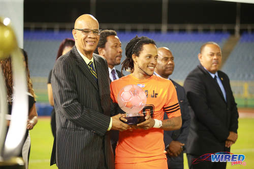 Photo: Acting CFU president Reginaal Francisco (left) presents the Caribbean Club Championship MVP trophy to Cibao and Haiti playmaker Charles Hérold Jr at the Hasely Crawford Stadium on 21 May 2017. (Courtesy Alan V Crane/Wired868)