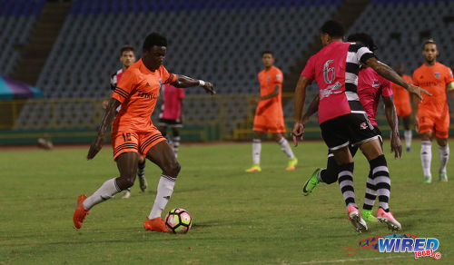 Photo: Cibao FC winger Patrick Soko (left) takes on Central FC full back Carlos Edwards during 2017 Caribbean Club Championship action at the Hasely Crawford Stadium on 18 May 2017. Soko scored the winner as Cibao edged Central for a place in the regional final. (Courtesy Sean Morrison/Wired868)