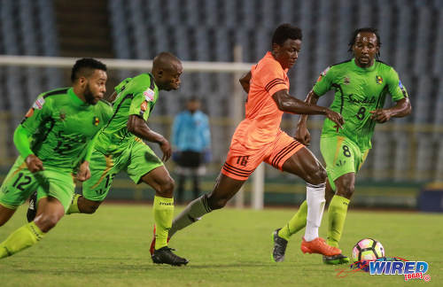 Photo: Cibao FC winger Patrick Soko (centre) charges past Grenades FC players (from right) Zaccheus Polius, Karanja Mack and Blake Thompson during Caribbean Club Championship action at the Hasely Crawford Stadium on 16 May 2017. (Courtesy Nicholas Bhajan/Wired868)