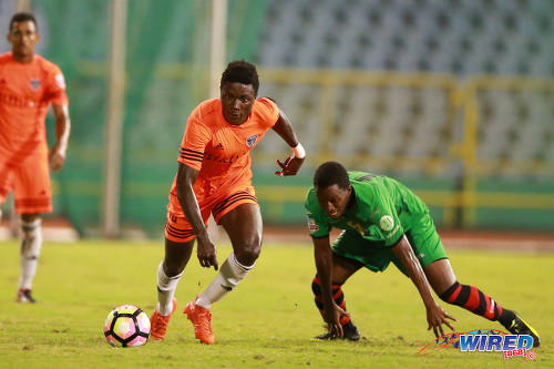 Photo: Cibao FC and Cameroon winger Patrick Soko (left) leaves San Juan Jabloteh left back Kion Joseph for dead during the Caribbean Club Championship final on 21 May 2017 at the Hasely Crawford Stadium in Port of Spain. Cibao won 1-0. (Courtesy Allan V Crane/Wired868)