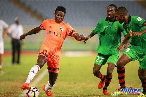 Photo: Cibao FC winger Patrick Soko (left) takes on San Juan Jabloteh players Adrian Reid (right) and Nathan Lewis during the Caribbean Club Championship final on 21 May 2017 at the Hasely Crawford Stadium in Port of Spain. Cibao won 1-0. (Courtesy Allan V Crane/Wired868)