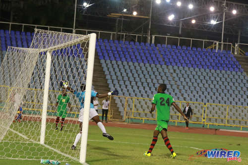 Photo: San Juan Jabloteh goalkeeper Javon Sample (centre) claws away a late effort by Portmore United attacker Jeremie Lynch during 2017 Caribbean Club Championship action at the Hasely Crawford Stadium on 18 May 2017. Jabloteh held on for a 2-2 draw to book their place in the regional final. (Courtesy Sean Morrison/Wired868)