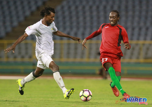 Photo: San Juan Jabloteh winger Nathan Lewis (right) takes on an opponent from Racing Club during 2017 Caribbean Club Championship action at the Hasely Crawford Stadium on 14 May 2017. Lewis scored the opener as Jabloteh won 2-0. (Courtesy Nicholas Bhajan/Wired868)