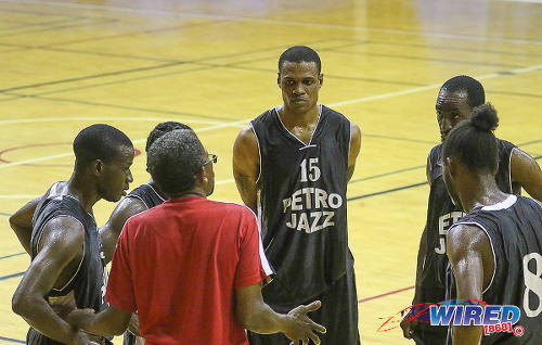 Photo: Members of the Petro Jazz basketball team have a mid-game chat. (Courtesy Sean Morrison/Wired868)