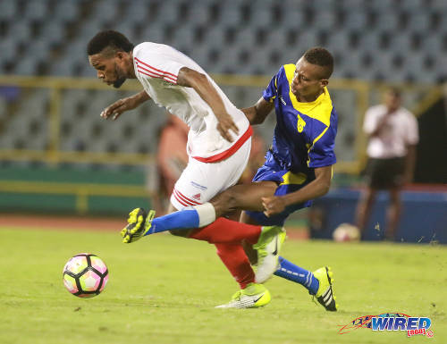 Photo: Portmore United winger Cleon Pryce (left) tries to escape from a challenge by a Racing Club defender during Caribbean Club Championship action at the Hasely Crawford Stadium on 16 May 2017. (Courtesy Nicholas Bhajan/Wired868)