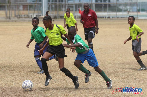 Photo: Adrenaline FA attacker Lu Ann Craig (left) takes on the Febeau Government Primary defence during RBNYL Under-11 action at Constantine Park in Macoya on 6 May 2017. (Courtesy Sean Morrison/Wired868)