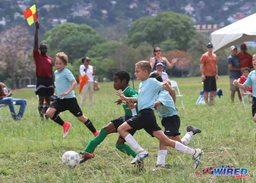 Photo: A flag from the referee's assistant (far left) thwarts Harvard SC attacker Mikel John as he closes in on the QPCC '2' goal during RBNYL North Zone U-11 action at the Queen's Park Savannah in Port of Spain on 27 May 2017. (Courtesy Sean Morrison/Wired868)