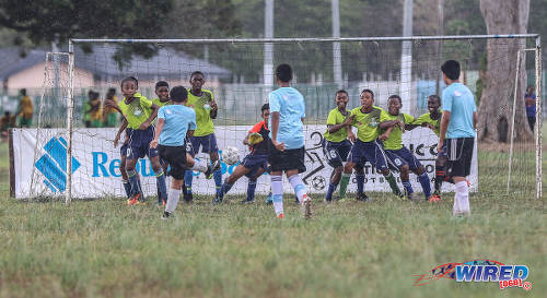 Photo: A QPCC player (left) tries to drive his free kick past the Santa Cruz SA wall during RBNYL North Zone U-13 action at the Queen's Park Savannah in Port of Spain on 27 May 2017. (Courtesy Sean Morrison/Wired868)