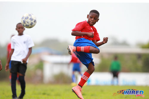 Photo: San Fernando SA attacker Jerome Barker (right) flicks the ball in mid-flight during RBNYL Under-11 action against Giving Back in La Brea on 21 May 2017. (Courtesy Allan V Crane/Wired868)